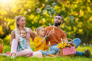 Joyful family picnicking in summer park