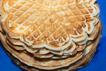 Stack of pancakes cooked in a waffle iron. Food on the national holiday of Maslenitsa. Ready meal for Breakfast..