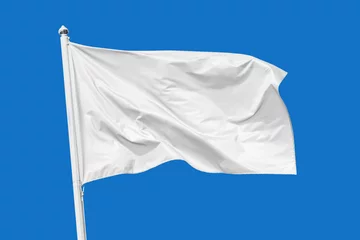 Fotobehang White flag waving in the wind on flagpole, isolated on blue background, closeup © rustamank