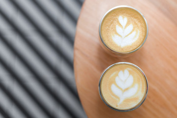 Coffee with a pattern on a foam in two glasses.