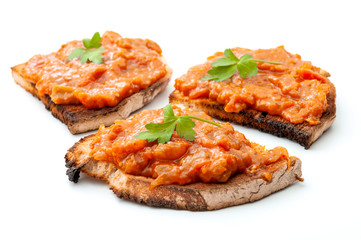 Traditional food from Romania concept with vegetable spread (romanian: zacusca) on slices of toast bread isolated on white background