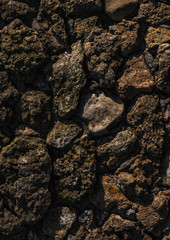 Stone texture. old rough stones tightly adjacent to each other. Dark stone floor or wall. Background from old stones.
