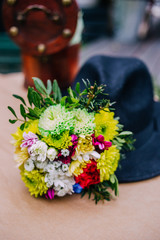 Bouquet of flowers and black hat.