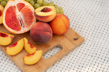 Close-up of a bouquet of fresh fruits on a cutting board. Picnic outside