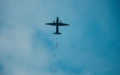 Army paratroopers jumping at air war action.