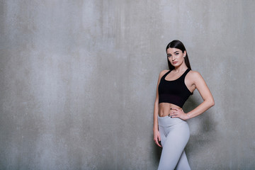 Fototapeta premium attractive fitness woman, trained female body, lifestyle portrait, caucasian model