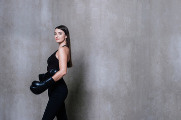 Fototapeta premium Image of young sports woman in tracksuit and black putting hands