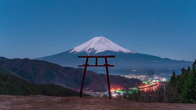 Mt Fuji with torii gate at night under fullmoon with stars