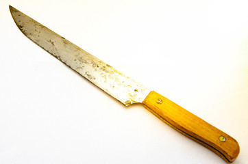 Old large rusty kitchen knife on a white background and in a hand. Blade, handle, parts of a knife in macro. Flare flare. CopySpace