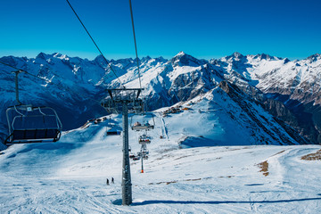 Cable car lift in mountain ski resort in winter sunny day