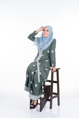 Beautiful female model in various poses wearing modern kebaya and hijab, a modern urban lifestyle apparel for Muslim women isolated on white background. Beauty and hijab fashion concept. Full length.
