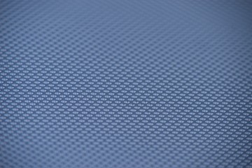 Perforated metal sheet on dark background