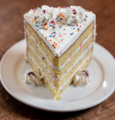 Slice of birthday style layer cake
