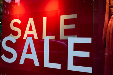 red sale sign in a shop january sales