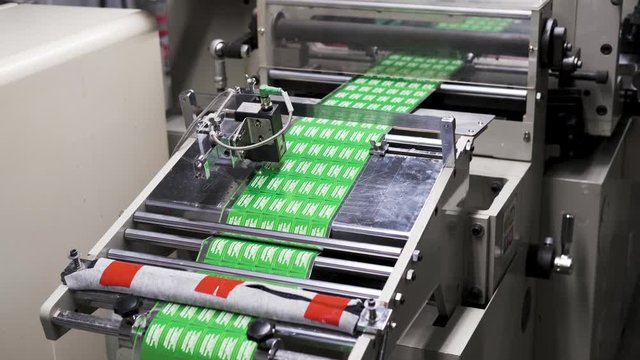 Close up Large offset printing press. moving polymer label conveyor typography facility and flexographic printing