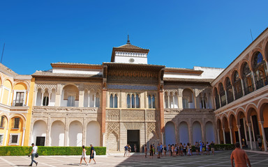 Fototapeta premium Royal Alcazar Place in Seville, Andalusia, Spain. People on the background