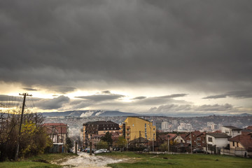 Fototapeta na wymiar Panoramic aerial view of Prishtina, capital city of Kosovo, seen from the Velania hill during a cloudy rainy afternoon in autumn