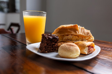 Orange Juice, Chocolate cake, Brazilian Snacks, Cheese bread, Eggs mixed