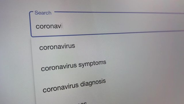 Close up coronavirus typing in searchbar of browser, searching information about virus on internet via browser on computer screen