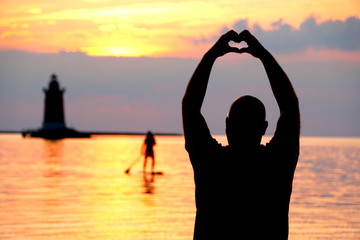 Silhouette of a man enjoying the sunset at Cape Henlopen State Park, Lewes, Delaware, U.S.A © Khairil