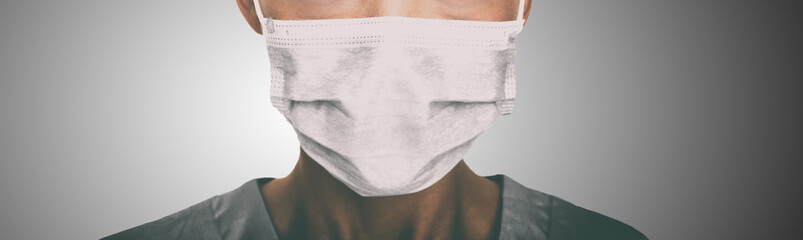 Doctor wearing protection face mask against coronavirus. Banner panorama medical staff preventive...