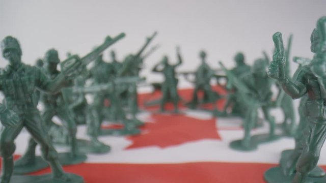 Toy soldiers lined up on Canadian Flag - symbolism of military service