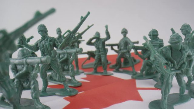 Toy soldiers lined up on Canadian Flag - symbolism of military service