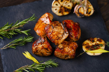 Grilled pork meat served on slate, grill and barbeque, restaurant menu. Delicious food for meat lovers