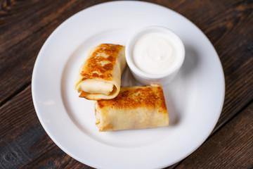 Crepes, pancakes, blinis with sour cream. Tasty morning meals, breakfast menu idea