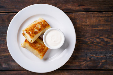 Crepes, pancakes, blinis with sour cream. Tasty morning meals, breakfast menu idea