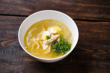 Hot chicken broth with fillet and boiled eggs. Healthy dietary tasty food, homemade meals