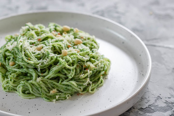 Green pasta with avocado, spinach and pine nuts