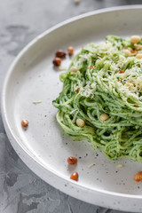 Green pasta with avocado, spinach and pine nuts
