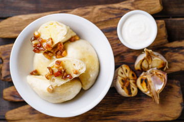 Vareniki dumplings, pierogi. Traditional Ukrainian food. Cooked and served with sour cream vareniki, pyrohy or dumplings, filled with potato