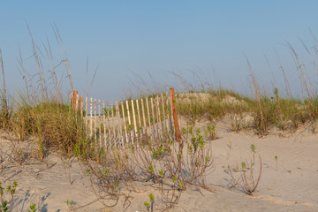 A typical wooden fence along the barrier sand dunes designed to keep tourists and children away...
