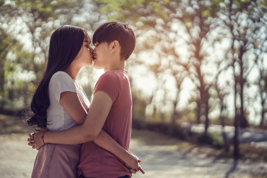 Happy LGBT lesbian couple embracing each other and kissing in outdoors. Same sex young married female couple Concept.