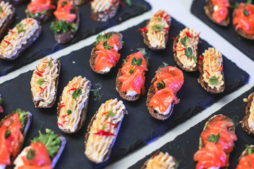 Beautifully decorated catering banquet table with variety of vegetables and different vegan vegetarian snacks on corporate christmas birthday party event or wedding celebration