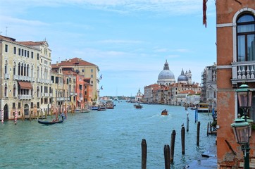 panoramic view of the wide Venetian canal, with the domes of the Basilica Della Salute in the background