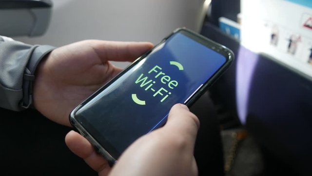 Mobile phone receiving the free wifi available inside an airplane traveling.