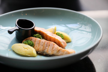Roasted salmon steak , baked salmon with salad fresh vegetable in restaurant