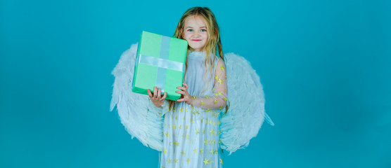 Valentines Day. Angel child from heaven gives you gift. Lovely and cute little Girl angel. Portrait of beautiful angel little girl with angels wings.