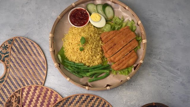 turmeric rice or nasi kunyit popular asian food with chicken cutlet