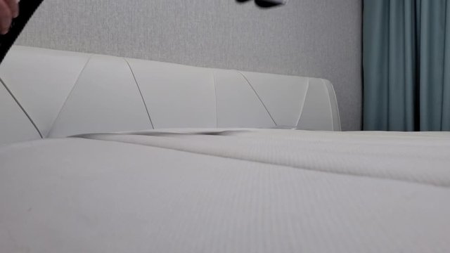 Close-up of male hands cleaning the mattress professional extraction method.