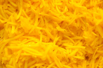 grated fresh stripes of pumpkin plum. orange vegetarian background