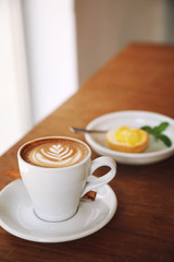 Coffee and Lemon Tart on wooden table