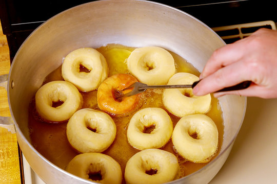 Flipping And Frying Donuts With Hole In Hot Oil.