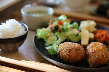 Beef Croquette with rice and salad japanese style Korokke on wooden