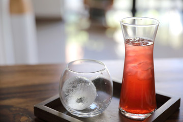 Strawberry iced tea on wood background