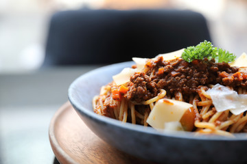 spaghetti Bolognese with minced beef and tomato sauce garnished with parmesan cheese and basil ,...