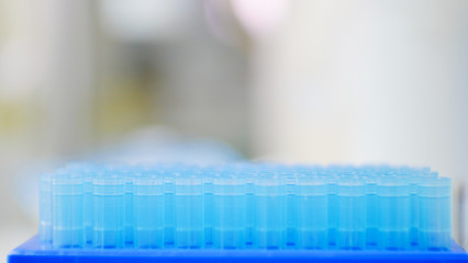 Blurred pipette tips in box.